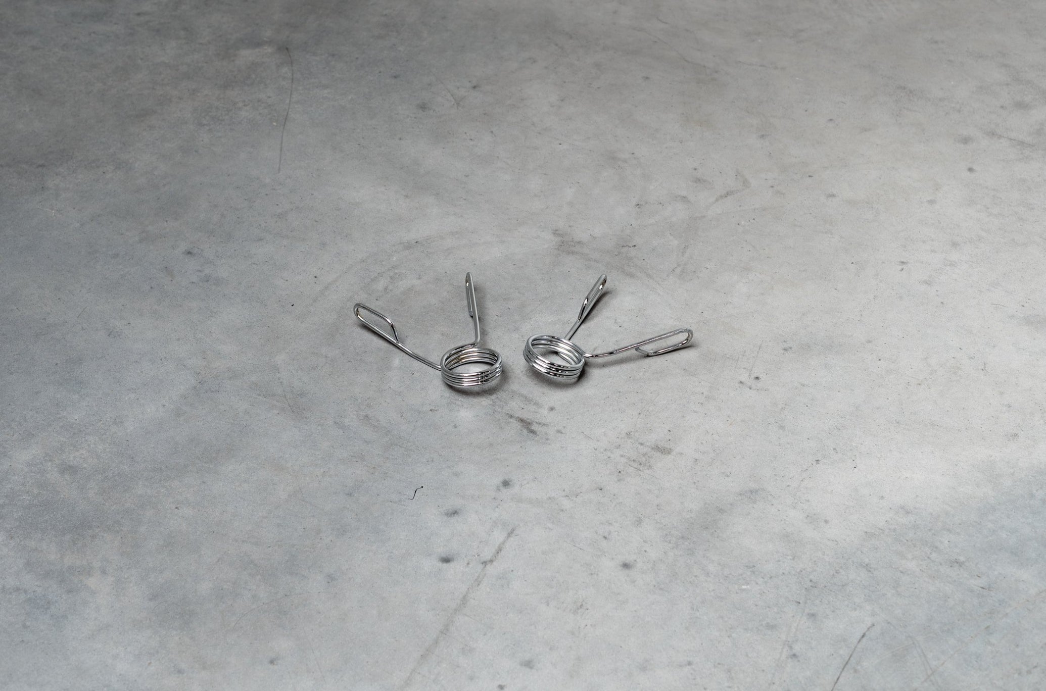 Spring Barbell Collars On Concrete